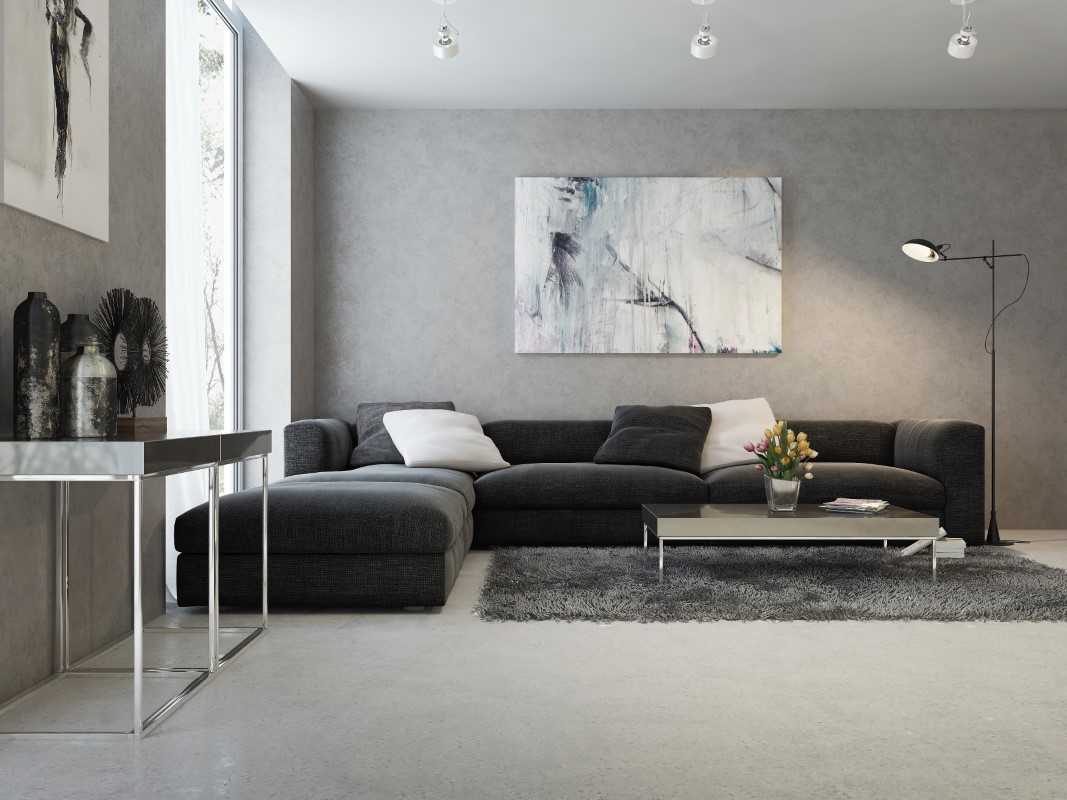 Salón moderno en tonos oscuros con suelo de hormigón en color gris claro